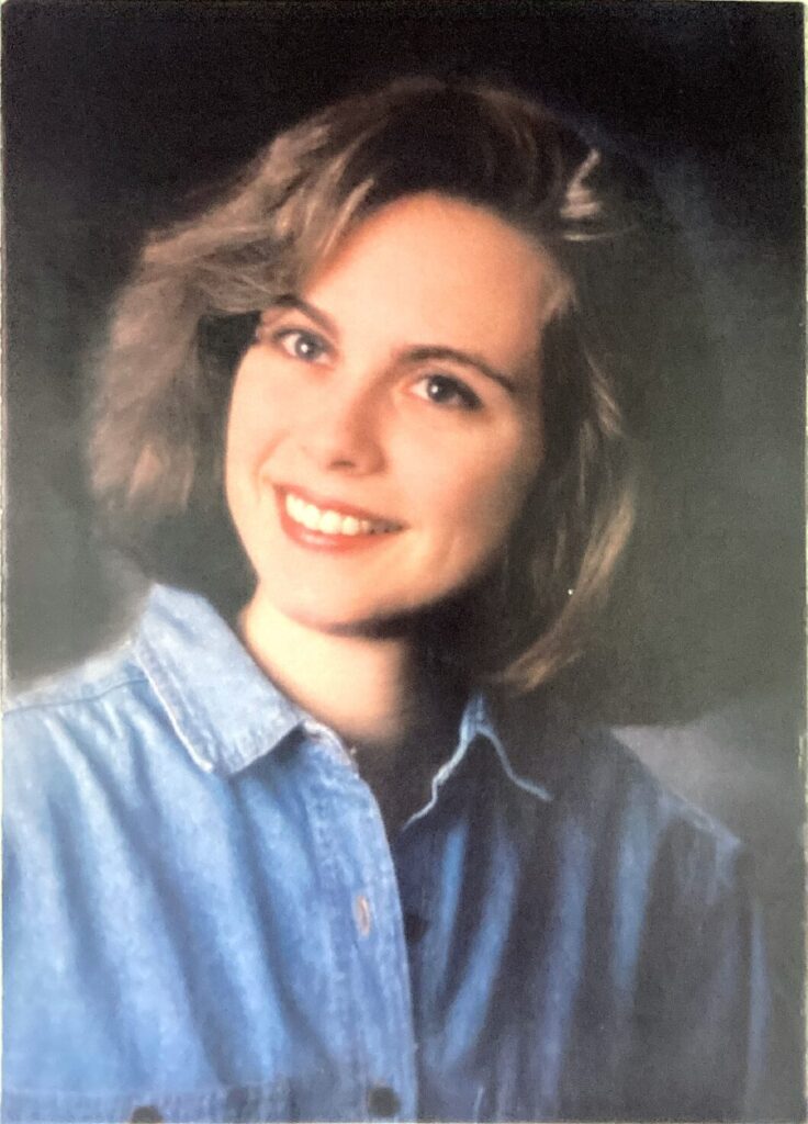 posed headshot photograph of Alicia Showalter Reynolds in a button up denim shirt