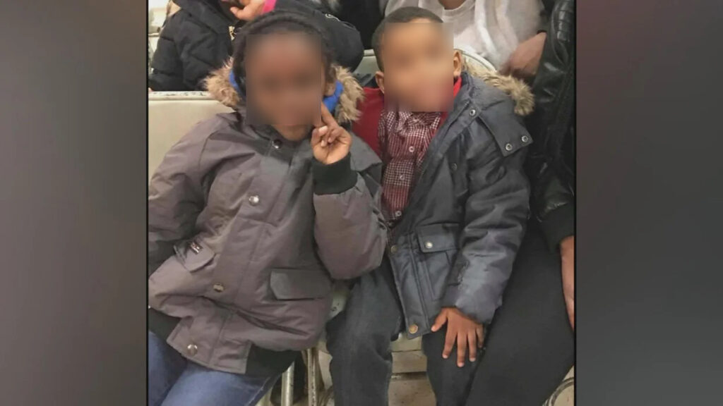 A warm, smiling portrait of Latarsha Sanders' two young children, Marlon and Lason, sitting close together.