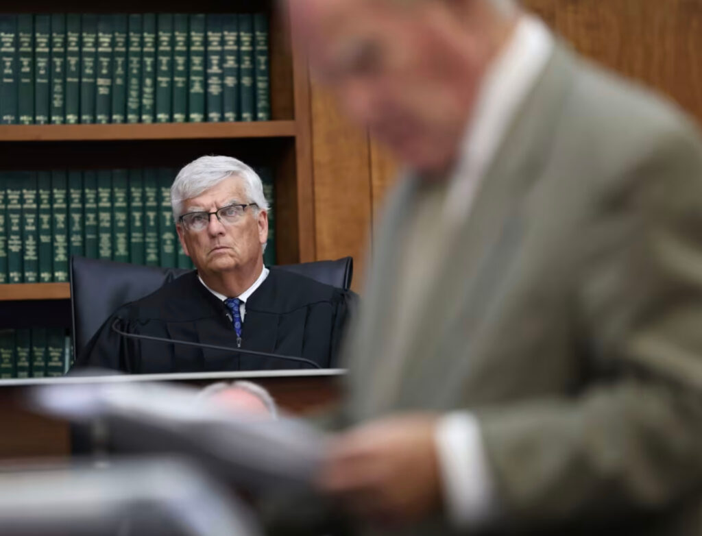 Judge William Sullivan in the Linday CLancy trial sits in his black judges robes wearing glasses with white hair