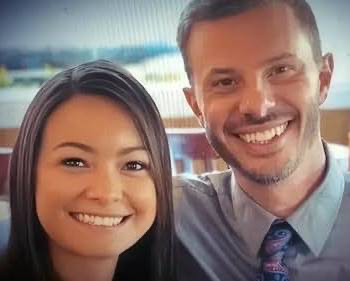 A medium shot of Mica and John-Paul Miller smiling directly at the camera in a posed couple's photograph.