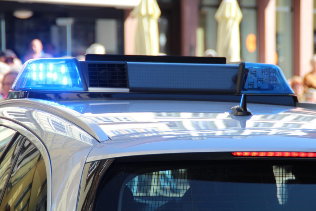 flashing blue lights on the top of a police car.