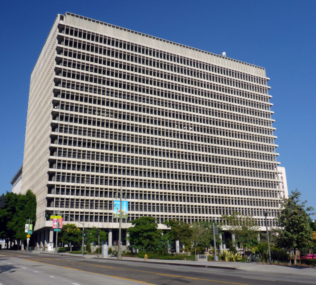 The exterior of the Clara Shortridge Foltz Criminal Justice Center, a large multi-story mid-century modern concrete courthouse building in downtown Los Angeles. 