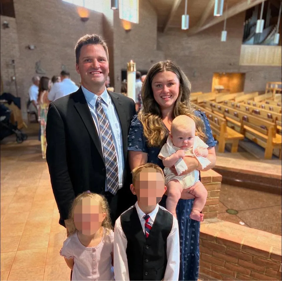 A young family in church smile for a picture