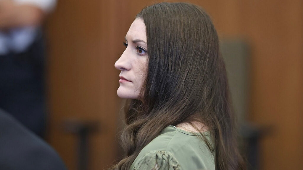 Lindsay Clany in the courtroom with long dark hair with a look of antici[pation on her face
