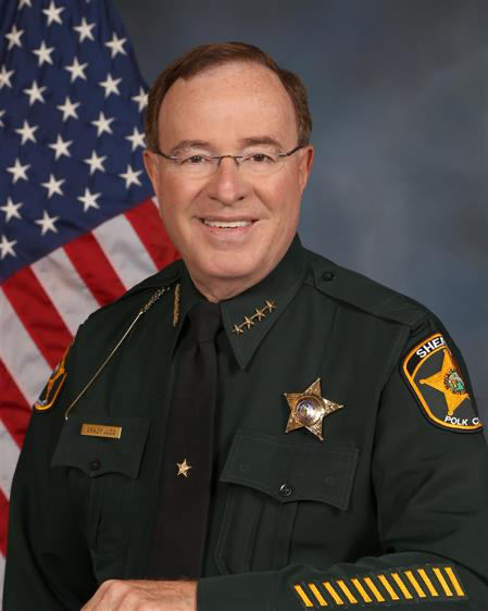 picture of Sheriff Grady Judd in his green Sheriff's uniform wearing glasses